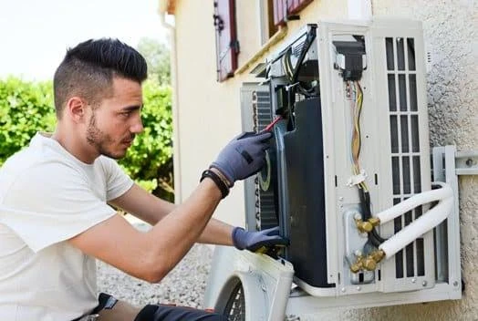 Illustrative technician inspecting an outdoor split-system unit