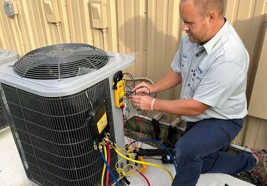 Illustrative technician measuring air conditioning system performance